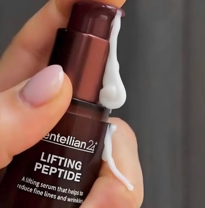 CENTELLIAN24 Lifting Peptide Serum bottle in hand with texture drip
