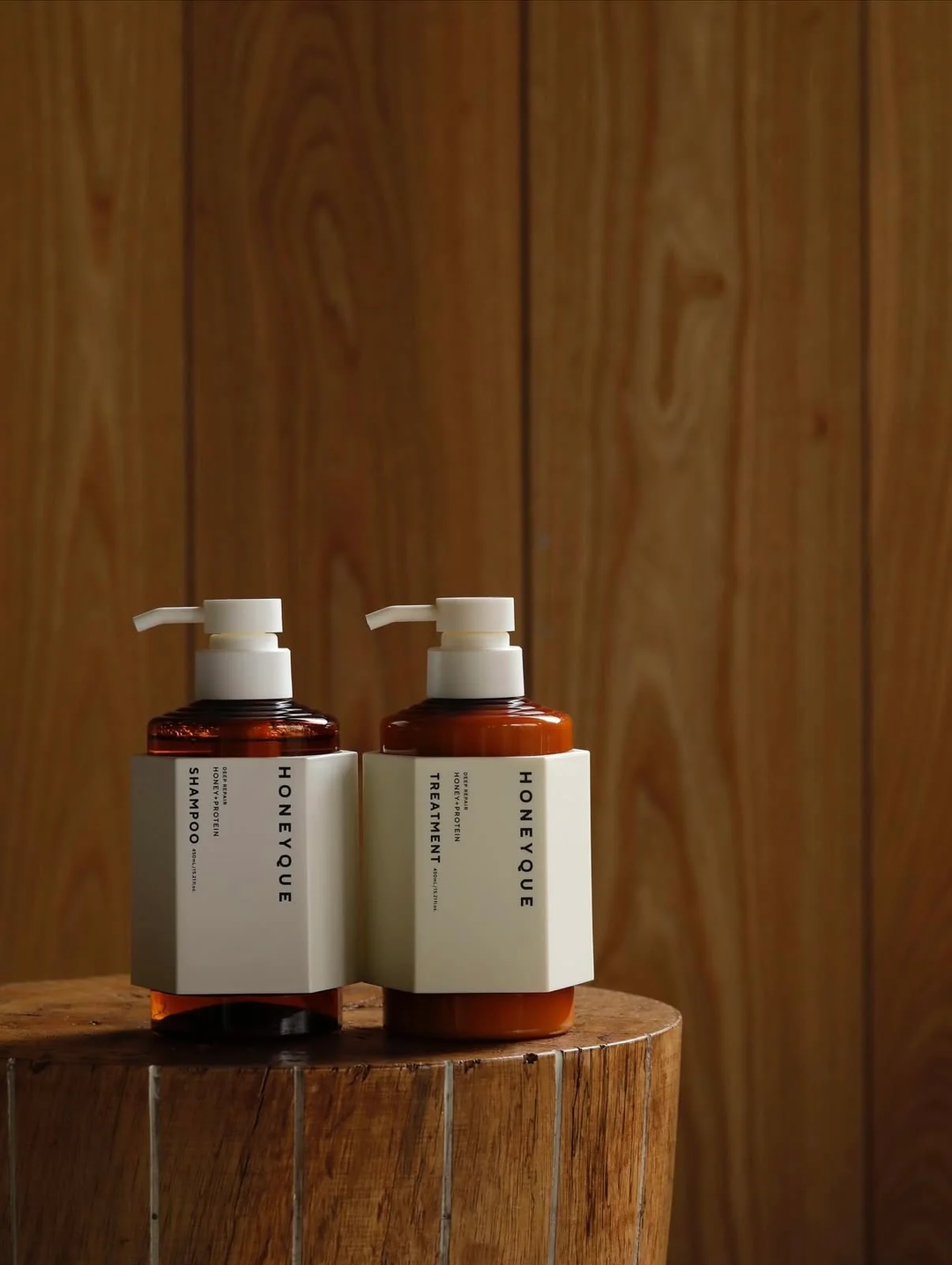 HONEYQUE Deep Repair Treatment 450ml - bottles on wooden table